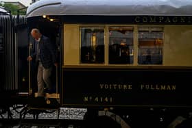 A man disembarks from the Venice Simplon-Orient-Express after arriving at Istanbul Station in Istanbul (Photo by YASIN AKGUL/AFP via Getty Images)