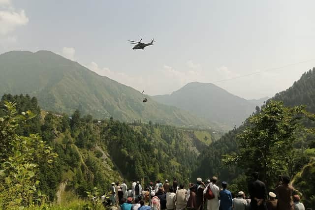 Eight people have spent six hours trapped inside a cable car in Pakistan