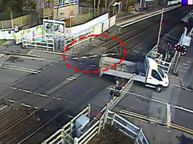 The van smashed through the level crossing barrier and dragged it along.
