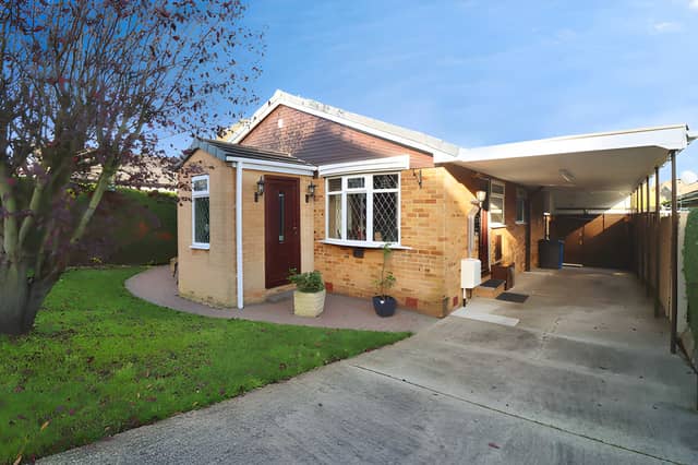 The Cromford Drive frontage leads to a detached bungalow with a driveway, carport and separate garage