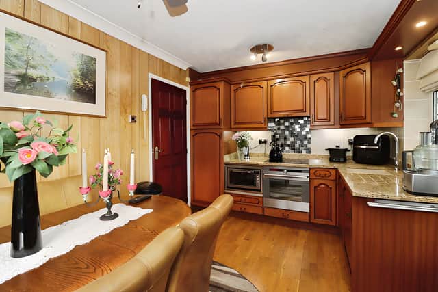The cottage-style fitted kitchen includes an integrated oven and hob alongside a spacious dining area for family meals and entertaining