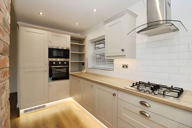 The open-plan kitchen and dining area creates a generous social space with integrated appliances and a second log burner