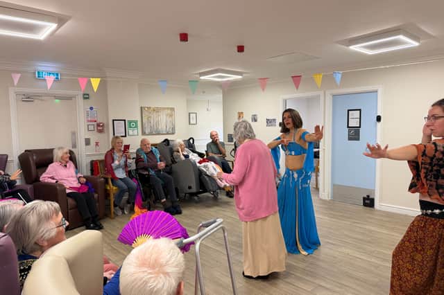 Residents being taught some dance moves