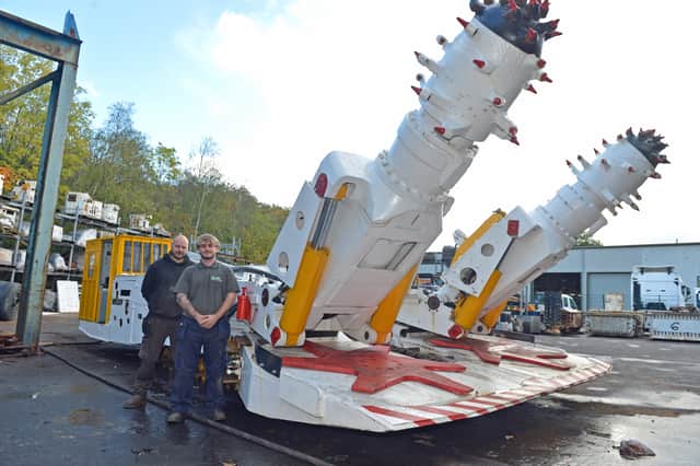 Josh and John standing next to a Dosco TB 2000 tunnel boring machine.