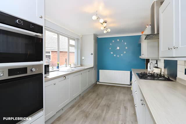 The modern kitchen diner features integrated appliances, generous work surfaces and space for family meals, with direct access to the rear garden