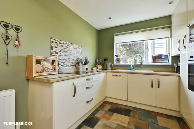 A modern kitchen provides a practical setting for everyday cooking, complementing the property's separate lounge and dining room.