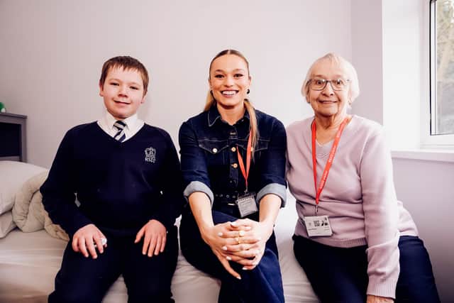 Jodie Ounsley with a pupil and their grandparent in the new residential block