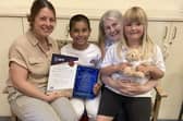 Katie Gilsenan (SENDCo and Inclusion Leader) and Nicky Kay (Welfare Officer) with two pupils and the award.
