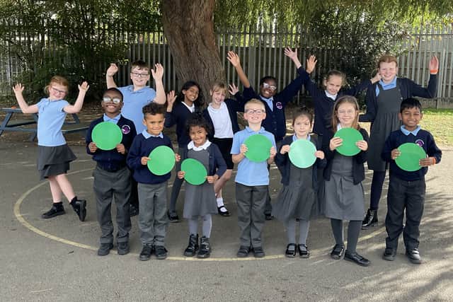 Children at St Laurence CofE Primary School celebrating their successful Ofsted report.