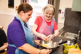 Resident with activities coordinator baking