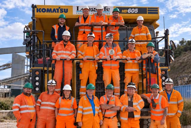 Ian Ollerenshaw (centre wearing badge) celebrates his 30 years' long service with his colleagues at Longcliffe Quarries Ltd