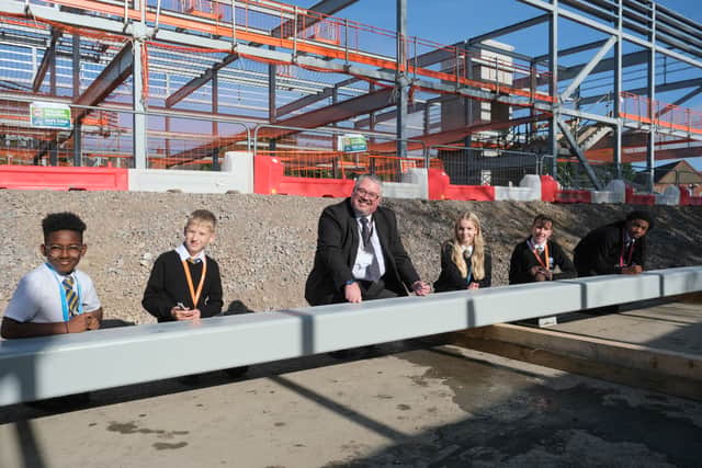 Nick Holmes, Associate Principal at Mercia Academy, with students signing the steel beam