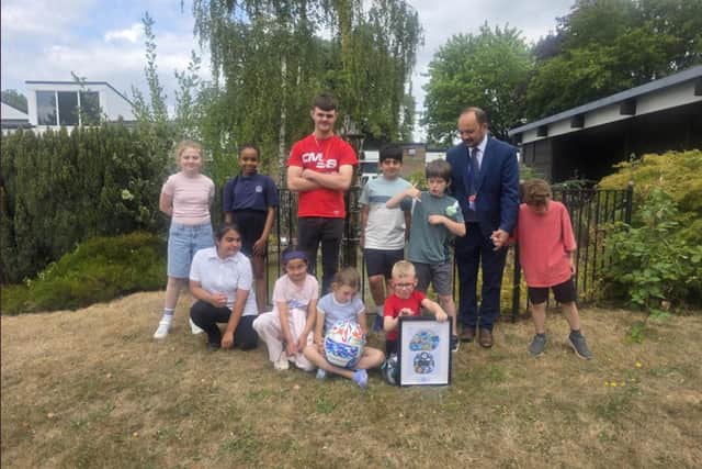 Caleb McDuff with students and headteacher Paul Burrows from The Royal School for the Deaf 