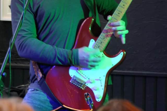 From the stage to the building trade: Marv White performing during his 12-year career as a professional musician, before swapping his guitar for a plastering trowel and eventually launching Chesterfield-based MW Media Walls