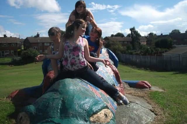 Young people enjoying Derek the dinosaur in 2010