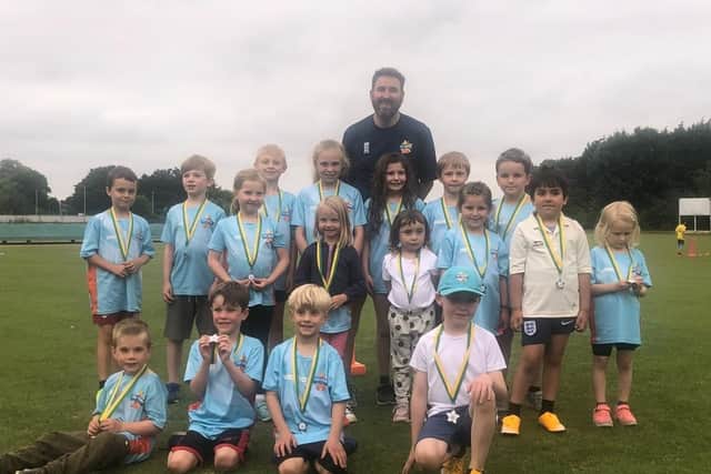 Young members of a Glapwell Colliery Cricket Club children's side with coach