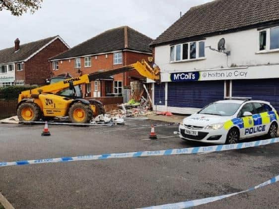 This was the scene after a JCB was used to target the ATM at the McColls store on in Holton-le-Clay, Lincolnshire.