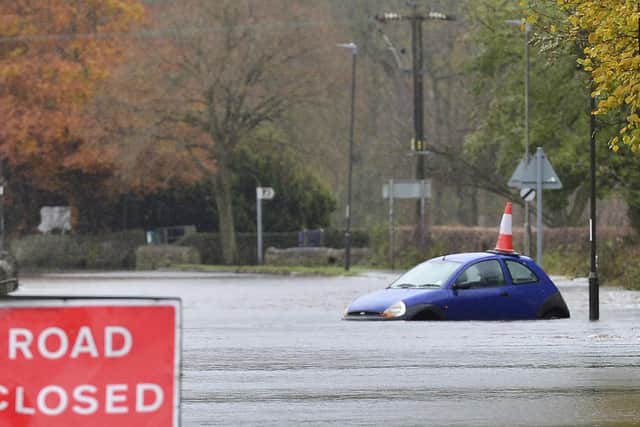 A swollen River Derwent floods a road in Darley Dale, Derbyshire.