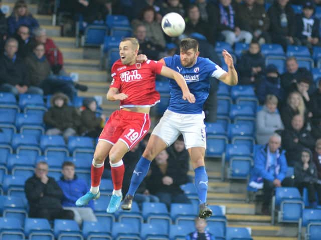 Chesterfield captain Will Evans challenges for the ball in the air against Chorley.
