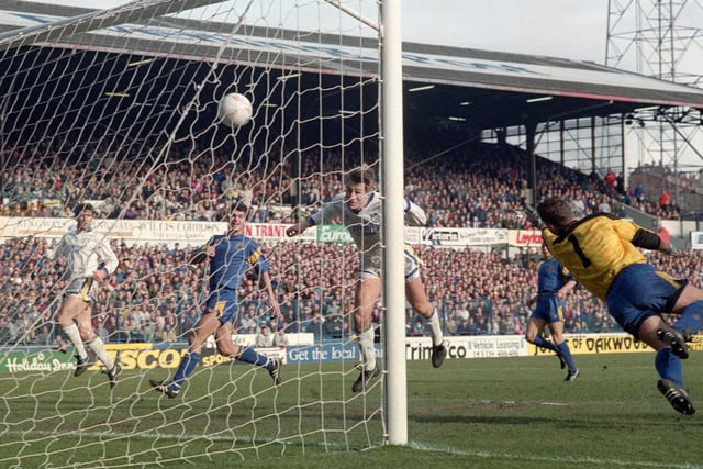 Lee Chapman heads home against Wimbledon at Elland Road in March 1992. He scored a hat-trick as Leeds won 5-1 .