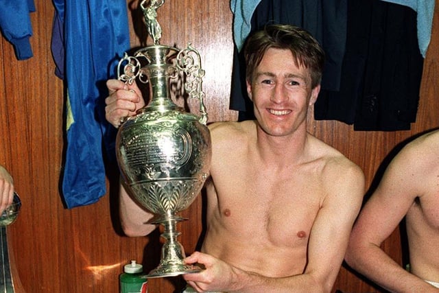 Lee Chapman with the First Division trophy in the Elland Road dressing room after Leeds beat Norwich on the final day of the season.