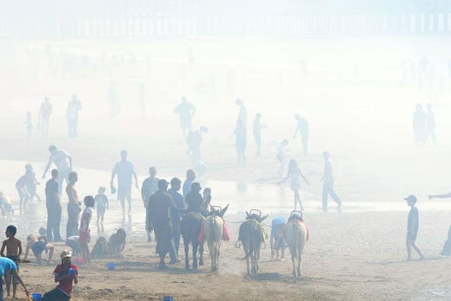 A display's smoke fumes create a fog on the beach