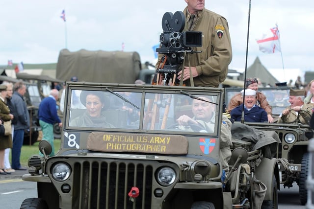 A war photographer's Jeep leads the parade