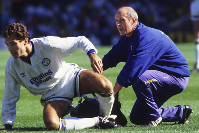 Physio Alan Sutton helps an injured Tony Dorigo.