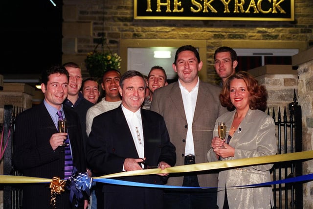 Leeds Rhinos coach Graham Murray cuts the tape to open the newly refurbished  Skyrack pub, watched by Leeds Tykes coach Phil Davies, Whitebreads area manager Kevin Rotchford, manager Carmen Daly and Leeds Tykes players.
