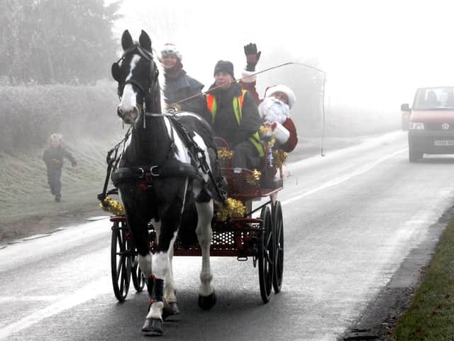 Who needs a sleigh anyway? Santa arrives by horse and carriage, 
at Irton Garden Centre.