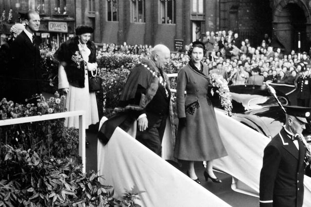 Pictured is Queen Elizabeth and Prince Philip leaving the Town Hall accompanied by the Mayor and Mayoress of Morley, Alderman Joseph Rhodes and his sister Miss Alice Rhodes. The photo was taken by  R. T. Cooper, a local pharmacist.