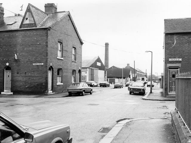 October 1983 and this view looks south-west along Cowper Road. Cowper Mount runs across in the foreground. Railings on the far right surround Harehills Conservative Club which faces onto Harehills Lane.