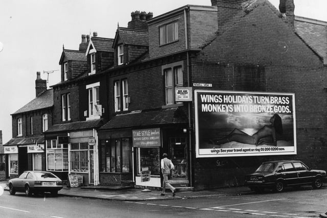 Harehills Lane showing a row of shops in March 1982. These include Tyme Style Jewellers, Anglia Building Society and Paul, hair stylist. The junction with Nowell View is on the right.