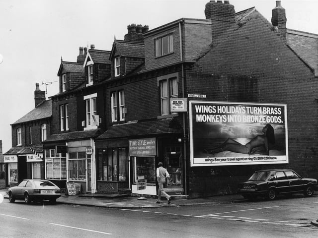 Harehills Lane showing a row of shops in March 1982. These include Tyme Style Jewellers, Anglia Building Society and Paul, hair stylist. The junction with Nowell View is on the right.
