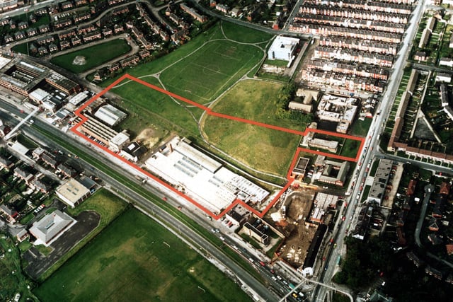 A colour aerial view showing York Road, with Harehills Lane on the right in March 1985. Factories and warehouses are in the centre. In the top left is semi-detached housing of Torre Hill and Torre Crescent.