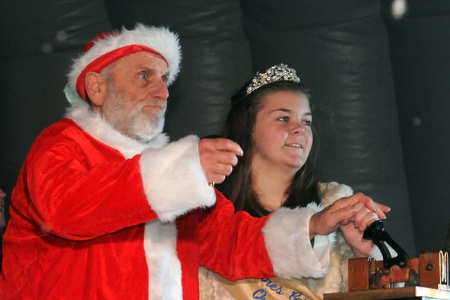 David Wood as Father Christmas pulls the lever at St Annes 2014 festive lights switch-on with then Carnival Queen Charlotte Griffiths