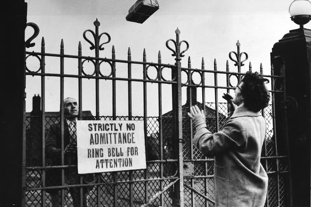 January 1962 and Eileen Sykes throws a parcel over the gates of Oakwell Hospital in Birstall for her son, an ambulance driver. The hospital was treating five patients who had smallpox.
