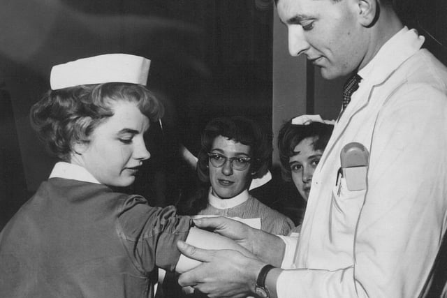Dr. R. M. Holman vaccinates Sister D. Bradley against smallpox at St James's Hospital in 1962. Staff in Leeds hospitals were vaccinated as a precautionary measure.
