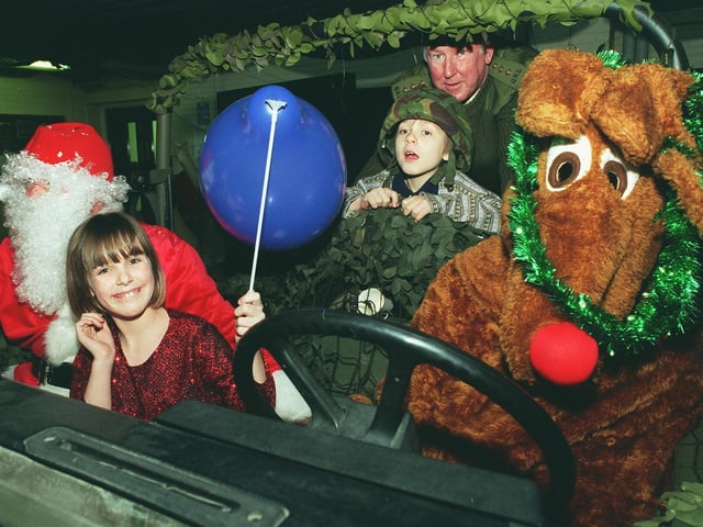 Santa and Rudolf hitch a lift during a party at Carlton Barracks in Leeds with, from left, Michelle Clenand and Chris Cardiss, and Capt Vaughan Westbrook. The Officer Training Corps organised the Christmas party for the children.
