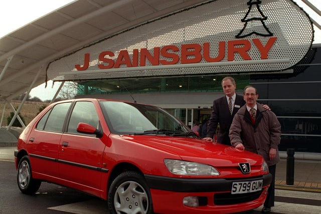 Christmas arrived early for this lucky Sainbury's customer. Manager of the Moor Allerton store Paul Robinson (left) handed over a new Peugeot 306 to Arnold Abrams. His name was randomly selected from more than 2,000 entries for the car draw.