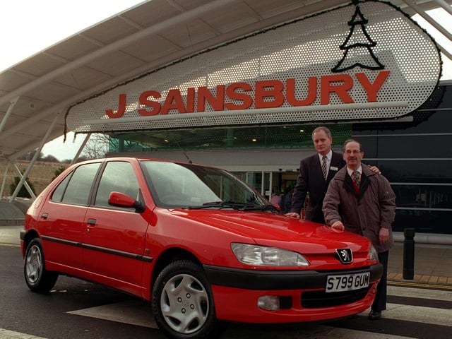 Christmas arrived early for this lucky Sainbury's customer. Manager of the Moor Allerton store Paul Robinson, left, handed over a new Peugeot 306 to Arnold Abrams. His name was randomly selected from more than 2,000 entries for the car draw.