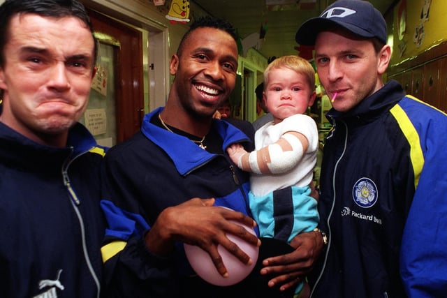 Gary Kelly pulls the same face as 17-month-old Jamie Underdown while Lucas Radebe and Lee Sharpe try to get a smile out of him during a visit by the team to the childrens wards at St James's Hospital.