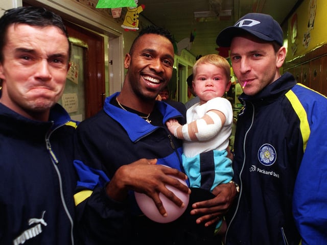 Gary Kelly pulls the same face as 17-month-old Jamie Underdown while Lucas Radebe and Lee Sharpe try to get a smile out of him during a visit by the team to the childrens wards at St James's Hospital.
