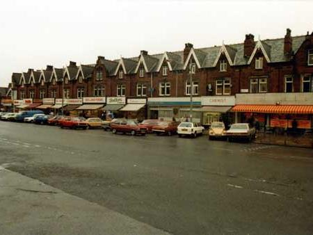 Cars are parked along the road in front of the shops which features the Roundhay Road store on the right in August 1980.