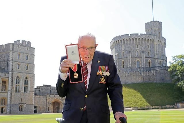 Captain Tom Moore poses with his medal after being made a Knight Bachelor during an investiture at Windsor Castle