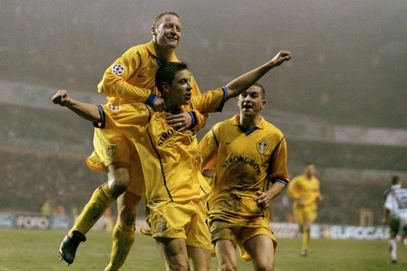 Alan Smith celebrates with his team-mates after scoring Leeds United's third goal.