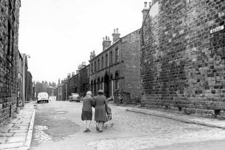 The cobbles of Morley's New Street in August 1968. Two women pushing a pram can be seen crossing the cobbles.