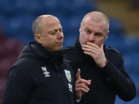 Burnley's English manager Sean Dyche (R) talks to assistant Ian Woan (L) ahead of kick off of at Turf Moor.