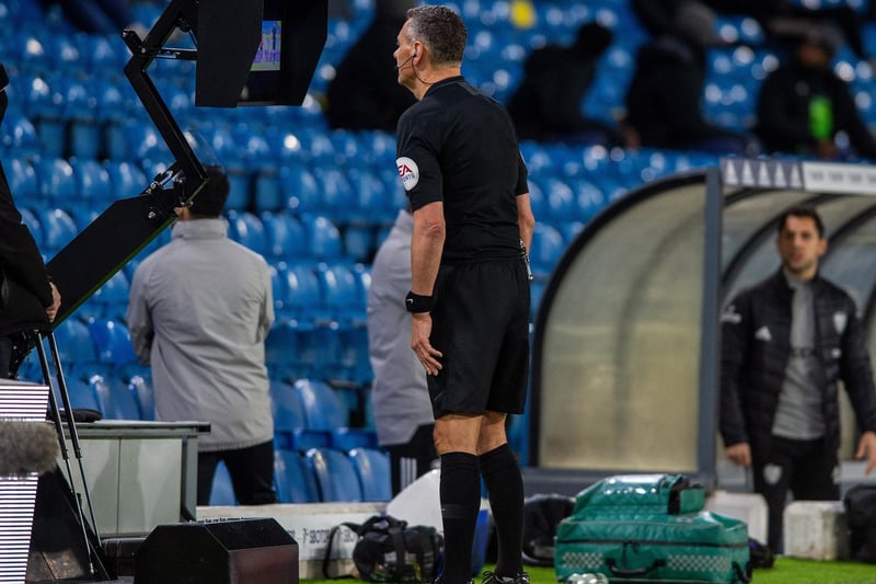 Referee Andre Marriner consults VAR after giving a penalty for Southampton as Nathan Tella falls under the challenge of Diego Llorente. It's overturned!