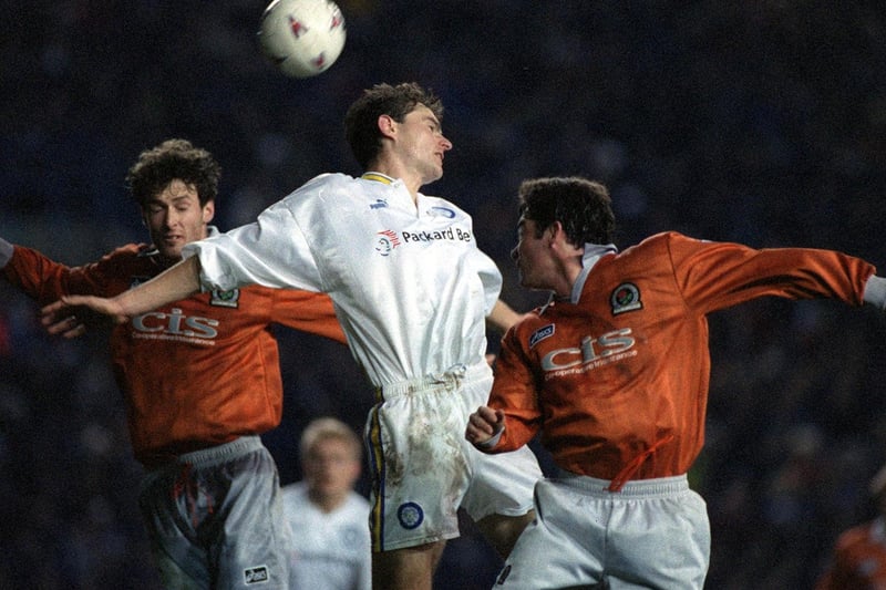 David Wetherall rises to win the ball against Blackburn's Chris Sutton (left) and Jeff Kenna.